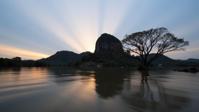 photograph, best quality, landscape of a Draconian Folded Sigiriya from inside of a Lagoon, Gradient mountains with Tree