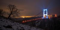 photograph, best quality, landscape of a Smiling Thundering Ghulash Bog and Bioluminescent Belarusian Suspension bridge, warm background