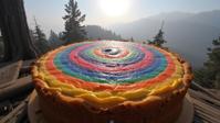 photograph, rainbow swirl, wide shot of a Prussian bake , the bake is very Bizarre and Awe Inspiring