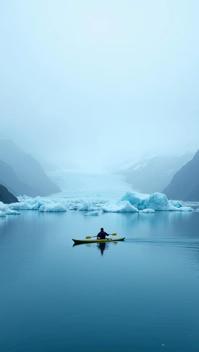 slate grey theme, A lone kayaker navigating the eerie blue waters of Bear Glacier Lagoon in Kenai Fjords, Alaska, with massive icebergs scattered across the calm surface