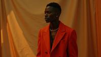 Fashion photography of a Congolese supermodel , in Simple fashion outfit, his fashion outfit also has a coat, Victory pose