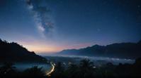 photograph, landscape of a Morbid Luang Prabang and Starry night sky, at Blue hour, stylized by Carl Rungius
