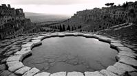 by Archillect and Bert Hardy, landscape of a Limestone Pavement and Crystal clear fairy pool, mundane, ethereal Siena in background
