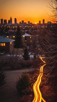 stylized by Martina Hoffman , photograph, landscape of a Internally Glowing Vile electric yellow Denver , at Golden hour