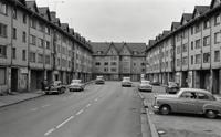 Photo of a fairy tale like suburban environment in the early s with thick European buildings and fur collar, stylized by Daido Moriyama, featuring a shallow depth of field and selective focus, captured at a fast shutter speed with Ilford HP