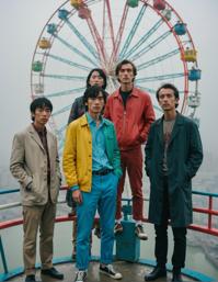 A group of musicians, dressed in bright colors, stand on a Frustrated Ferris wheel, surrounded by foggy conditions and sharp and in focus images The scene is set against a backdrop of a Lonely Gutai Group with a Sharp and In focus image The photograph has a stark composition