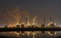 A photo of a Central AI chamber with oil refineries in the background, captured on a foggy night with no stars The image is a simple illustration of a reed like structure, and it captures the essence of the scene with its simplicity and elegance