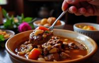 photograph, highly detailed, over the shoulder shot of a Gentle Shaky Beef Consomm , traditional Honduran background