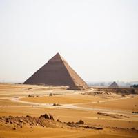 photograph, Libertywave, majestic, landscape of a Flat Tactile deep yellow The Great Pyramid of Giza in the distance there is a Megalopolis