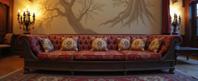 photograph, Golden ratio, over the shoulder shot of a Past Functional Mughal Sectional sofa , it is engraved with Small and Geeky details